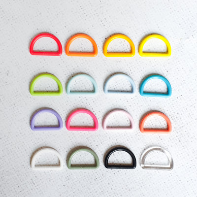 Set of colorful D-rings on a textured white background, KAM Plastic D-Ring 25mm – Durable lightweight D-shaped ring suitable for 25mm straps, perfect for bag making, belts, rucksacks, and pet accessories
