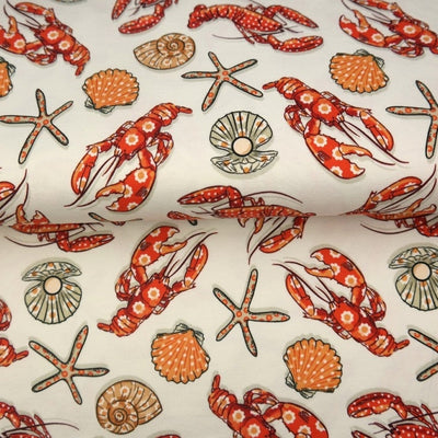 Fancy Seafood - Digital Printed Cotton Jersey, SKU: 25281-02. A soft and stretchy cotton jersey fabric featuring detailed digital prints of red-orange lobsters, starfish, and seashells on an off-white background. Ideal for beachwear, pyjamas, children’s clothing, and playful summer garments.