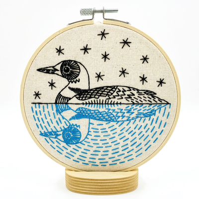 Embroidery hoop with a loon design on fabric Hook, Line & Tinker Loon Embroidery Kit – DIY embroidery kit with printed cotton fabric, 6″ hoop, floss, needle and instructions – serene loon design, beginner friendly