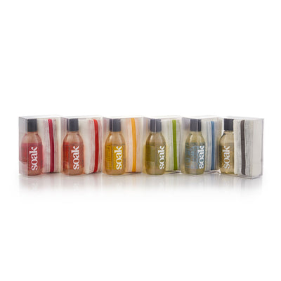 Soak Wash Eco Wash Bag SoakBox bundle – travel laundry soap and mesh wash bag
Set of six small bottles with colorful labels on a striped pouch labeled 'soak' against a white background.