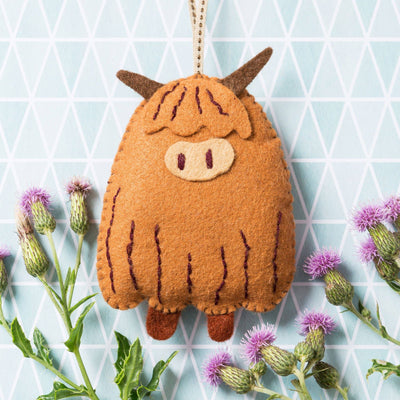 Felt Highland cow ornament with thistle flowers on a geometric patterned background Corinne Lapierre Llama Felt Craft Mini Kit – complete wool felt sewing kit with materials and instructions to hand-stitch a Llama