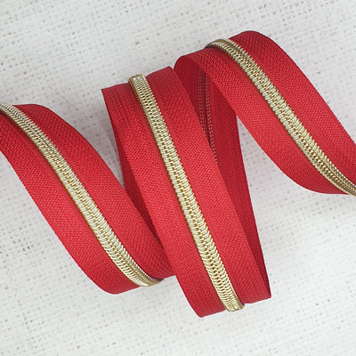 Poppy Red Zipper Tape with Light Gold Coil Teeth - Size 5 Zip - Shop online and in store at Purple Stitches, Basingstoke, Hampshire UK