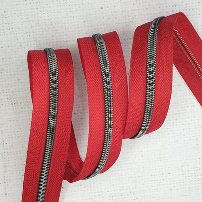 Poppy Red Zipper Tape with Gunmetal Coil Teeth - Size 5 Zip - Shop online and in store at Purple Stitches, Basingstoke, Hampshire UK