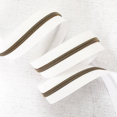 White Zipper Tape with Antique Brass Coil Teeth - Size 5 Zip - Shop online and in store at Purple Stitches, Basingstoke, Hampshire UK